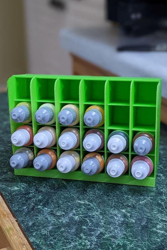 A one half oz paint bottle holder that holds 24 bottles