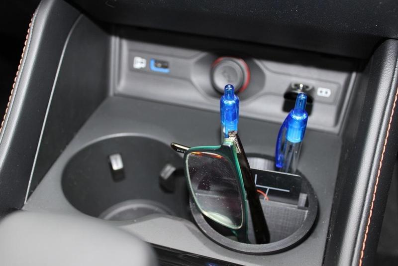 Car cup holder organiser for pens, cards and glasses.