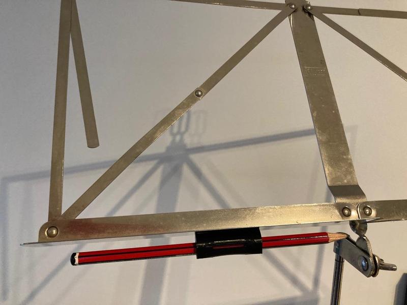 Pencil grip with magnet for music stand