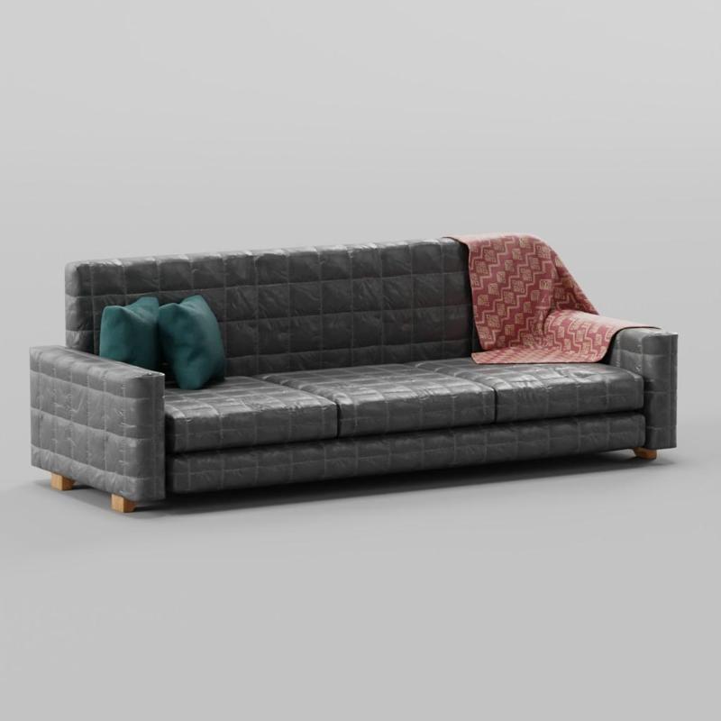 Sofa with two pillows and a blanket
