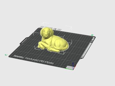 A figurine of a dog lying down