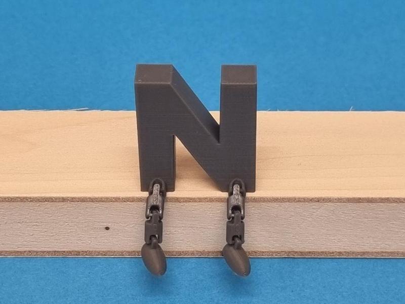 N featuring articulated legs