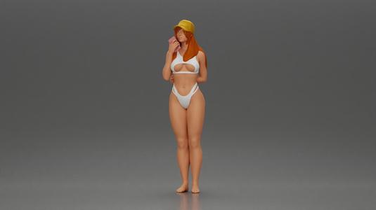 girl in a white bikini holding a phone on the beach and wearing a cap