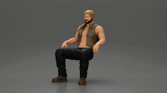 Muscular Bearded Man in Beanie Vest Pants Sitting Casually Relaxed