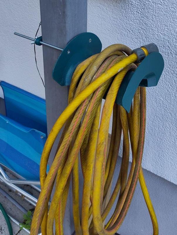 Garden hose holder to mount against a post or a wall