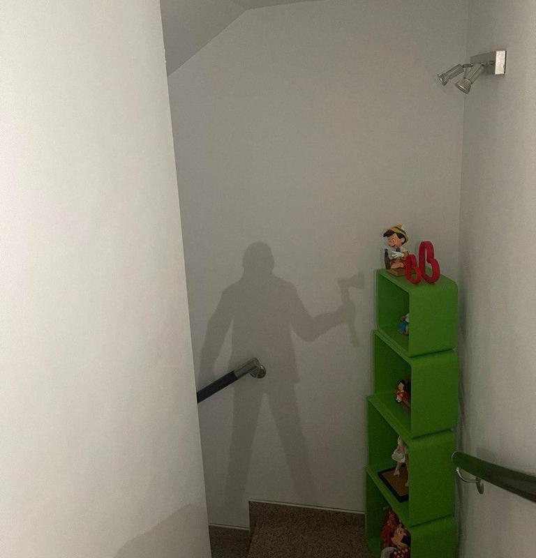 Silhouette of a man with an ax on a base