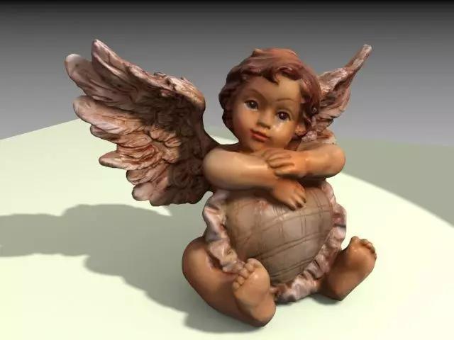 Angel figurine with heart shaped pillow