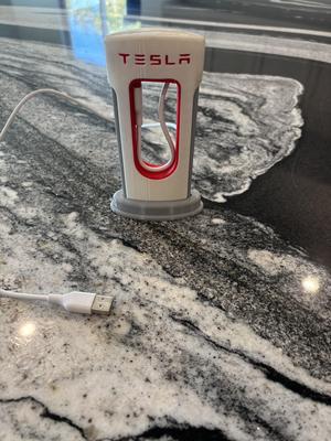 Type-C/Lightning Tesla SuperCharger Phone Charger with larger hole for charger to fit through.