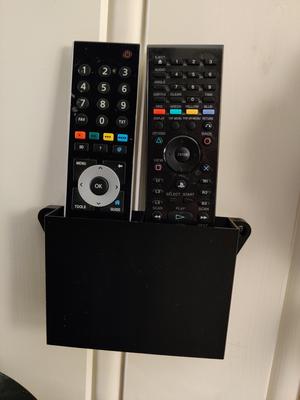 Wall mounted box for remotes