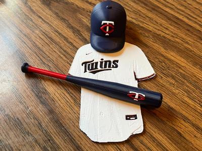 Minnesota Twins Jersey, a bat, and a hat