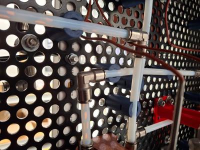 Holder for chemical hoses on perforated metal plates