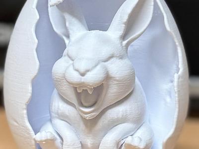 Cheeky laughing bunny in an egg