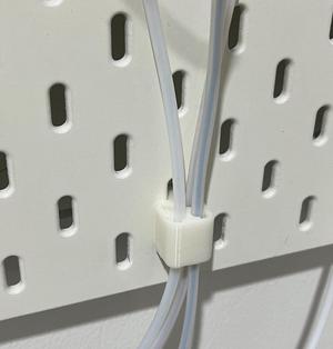 Quick-release PTFE tube holder for SKÅDIS