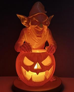 Halloween goblin with pumpkin