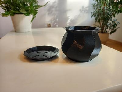 Spiral plant pot with drip tray.
