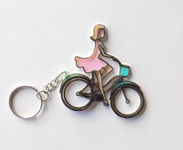 Key ring woman on bicycle