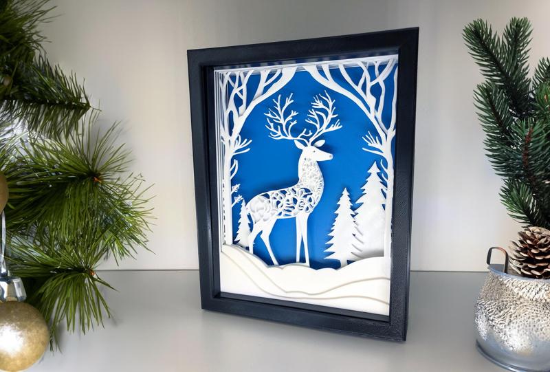 Stag in a winter landscape as a layered picture