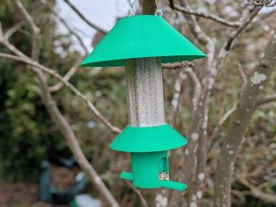 Bird feeder with rain guard, squirrel deterent hat