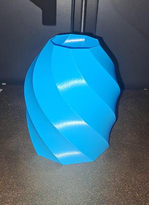 Vase in the shape of a spiral projectile.