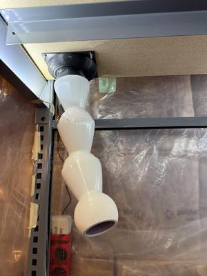 Exhaust air duct venting from enclosed shelving to outside