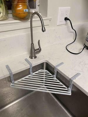 Hook for supporting metal ledge in sink under filtered water dispenser