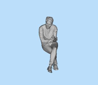 Man sitting and listening to others talking
