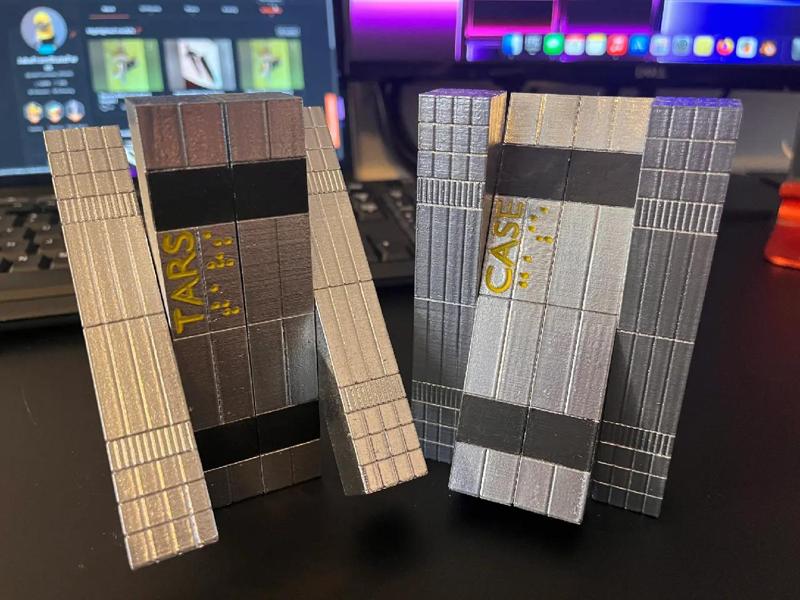 Articulated T.A.R.S, C.A.S.E, K.I.P.P, and P.L.E.X Interstellar print in place robots.   