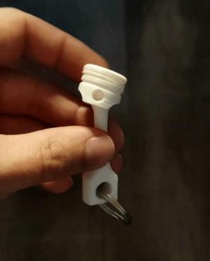 Articulated piston keychain