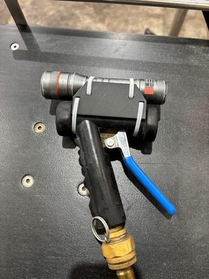 Flashlight holder for hose spray nozzle