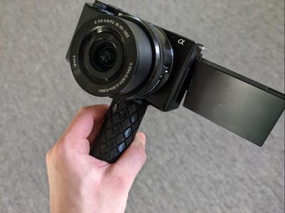 Camera handle for smaller cameras