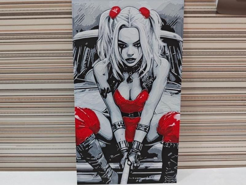 Hueforge Harley Quinn atop a vehicle