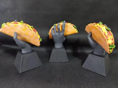 Hand holding a Mexican Taco