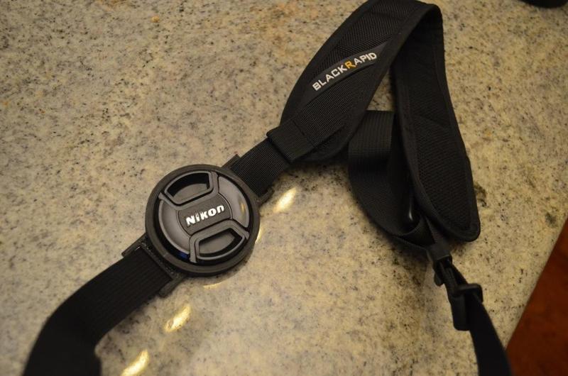 Lens cap holder for both 58 and 52 mm lens diameters