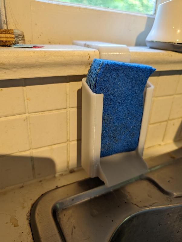 Windowsill mounted sponge holder