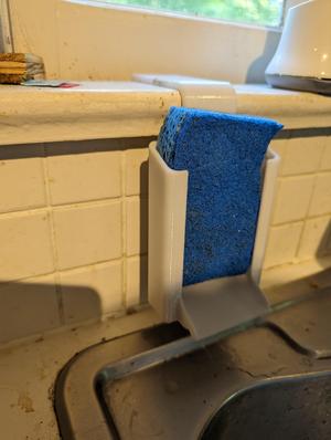 Windowsill mounted sponge holder