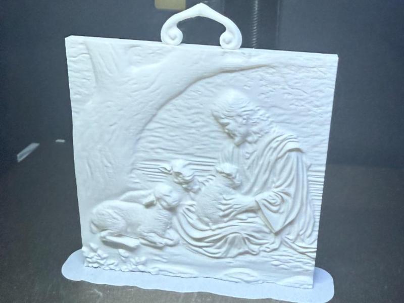Jesus holding a lamb under tree