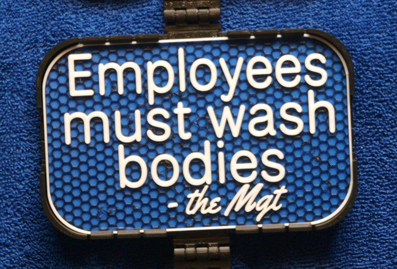 Mgt Sign: Employees must wash bodies