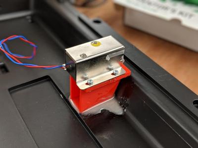 Solenoid mount for locking briefcase