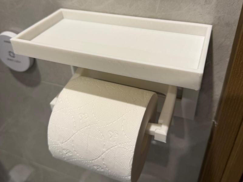 Phone holder designed to fit a 100mm wide toilet paper roll holder