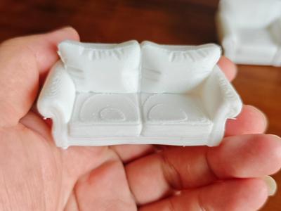 A two-seater sofa model, scalable for printing, serving as an engaging children's toy or an exquisite collectible figurine, complete with one-click Print in Place functionality