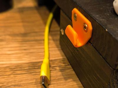 tiny USB cable hanger (c.a. 5 mm diam.) 