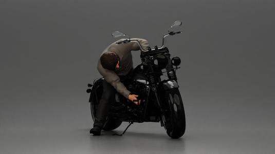 Man sitting on a vintage motorcycle, checking it for restoration
