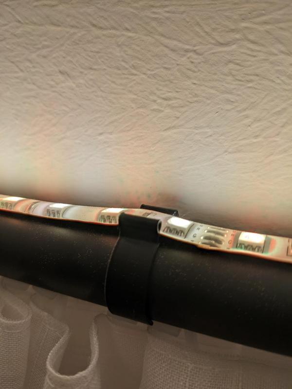 Clip for attaching LED strips to curtain rods