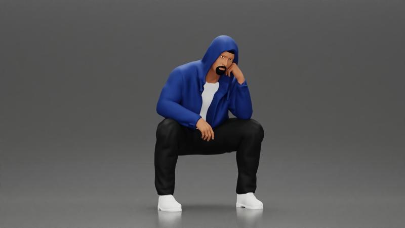 Thoughtful Man in Hoodie Squatting with Hand on His Face