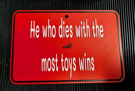 He who dies with the most toys wins funny sign