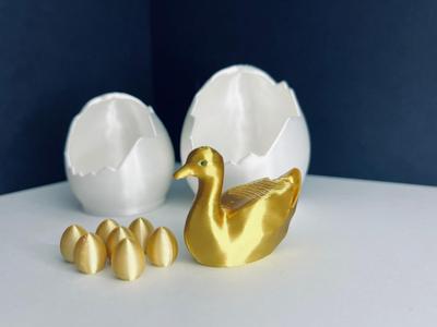 Golden goose with hatched egg and 7 golden eggs