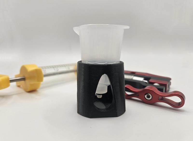 Bleed funnel with stopper holder