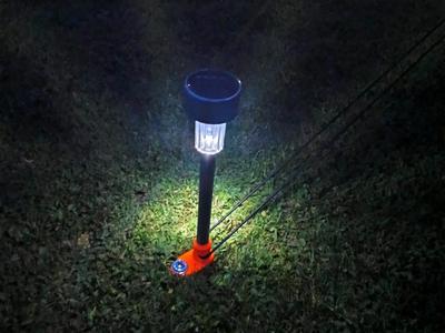 Solar lamp holder as tent guy line holder
