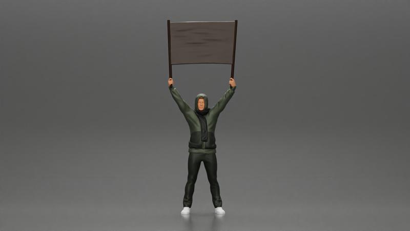 man in a hoodie and scarf is holding a banner