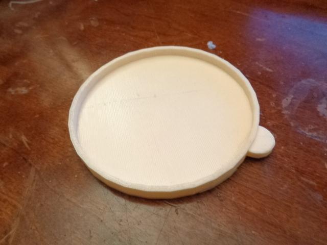 5.5 ounce cat food can lid.